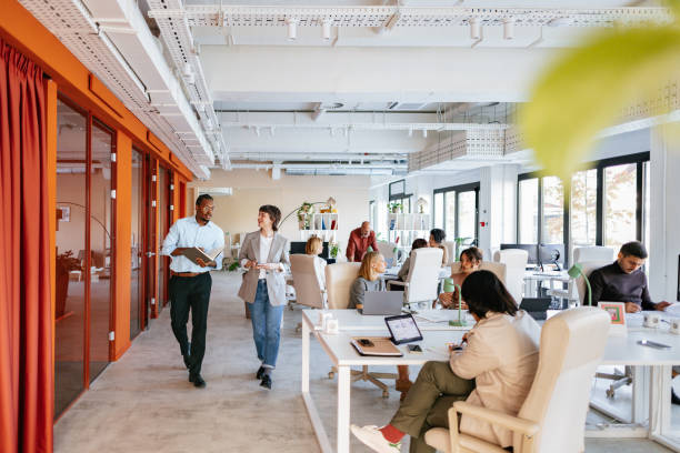 Group of professionals collaborating in a bright, modern office space designed for co-working and teamwork.